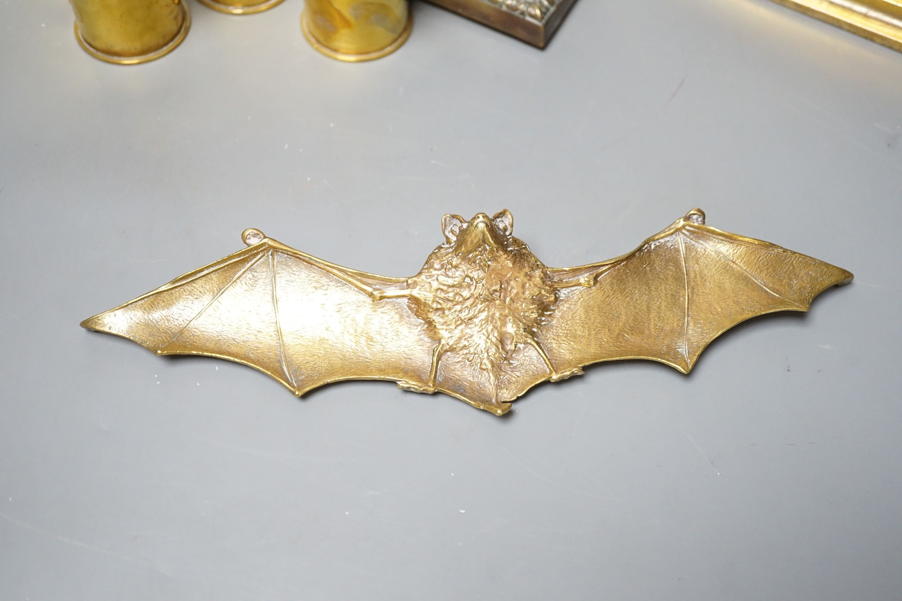 A brass ‘bat’ pin tray, two lion figures and sundry metalware, lion door stop 20 cms height x 25 cms width